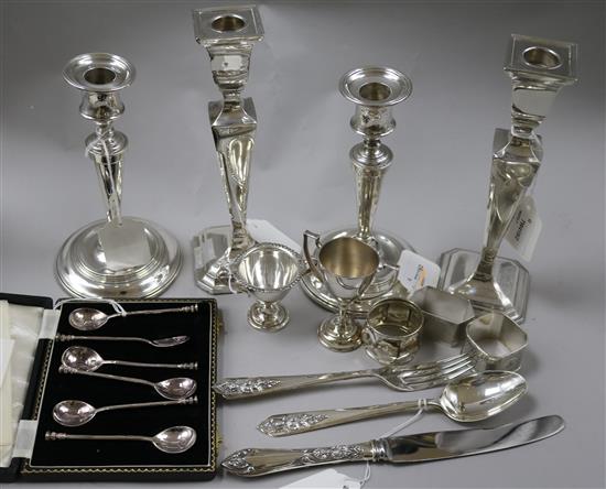 Two pairs of silver pillar candlesticks, three silver napkin rings, etc.
